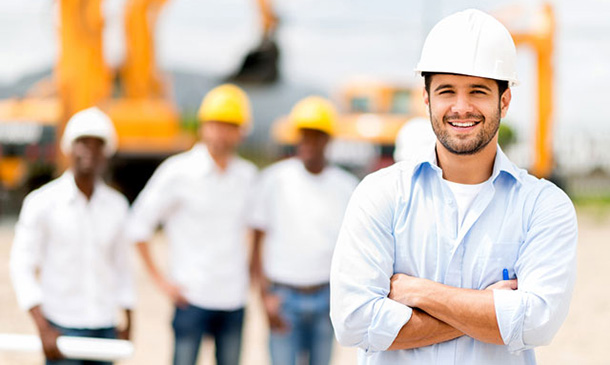 Male architect at a construction site looking happy